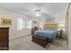 Comfortable bedroom features a window for natural light, neutral colors and a ceiling fan at 12434 W Fieldstone Dr, Sun City West, AZ 85375