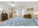 Bright bedroom featuring neutral walls, carpet, and a ceiling fan with a view of the en-suite bathroom at 12434 W Fieldstone Dr, Sun City West, AZ 85375