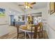 Cozy dining area with an oak table set near the open concept kitchen in a well-lit home at 12434 W Fieldstone Dr, Sun City West, AZ 85375