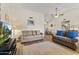 A modern living room features wood flooring, comfortable couches, and a ceiling fan for added comfort at 12434 W Fieldstone Dr, Sun City West, AZ 85375