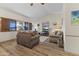 This charming living room features wood flooring, vaulted ceilings, and comfortable seating, creating a warm space at 12434 W Fieldstone Dr, Sun City West, AZ 85375