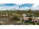 Wide shot of a neighborhood dotted with palm trees, showcasing a house with red tile roof and city views at 1307 W Palm Ln, Phoenix, AZ 85007