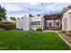 Expansive backyard featuring lush lawn and a cozy pergola-covered patio, perfect for outdoor entertaining at 1307 W Palm Ln, Phoenix, AZ 85007