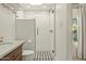 Tiled bathroom with glass shower, marble sink, and window providing natural light at 1307 W Palm Ln, Phoenix, AZ 85007