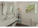 Bright bathroom with a vintage sink, hexagonal tile, and open shelving at 1307 W Palm Ln, Phoenix, AZ 85007