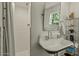 Stylish bathroom boasts a classic sink, walk-in shower, and shelving unit at 1307 W Palm Ln, Phoenix, AZ 85007