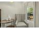 Bright sitting area with chair, side table and window with view of citrus tree at 1307 W Palm Ln, Phoenix, AZ 85007