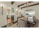 Charming dining room featuring wood beam ceilings, chandelier, and stylish decor, seamlessly flowing into the kitchen at 1307 W Palm Ln, Phoenix, AZ 85007