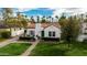 Beautiful home with a striking red tile roof, complemented by a green lawn, landscaped yard, and inviting walkway at 1307 W Palm Ln, Phoenix, AZ 85007