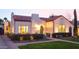 Charming home featuring a red tile roof, stucco walls, manicured landscaping, and pathway leading to an arched front door at 1307 W Palm Ln, Phoenix, AZ 85007