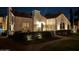 Night view of a home with well-lit landscaping and a red tile roof, creating a warm and inviting atmosphere at 1307 W Palm Ln, Phoenix, AZ 85007