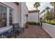 Outdoor patio area features brick pavers and comfortable seating outside the home's window and side entry at 1307 W Palm Ln, Phoenix, AZ 85007