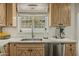 Bright kitchen featuring light wood cabinets, marble countertops, stainless steel appliances, and a window with a view at 1307 W Palm Ln, Phoenix, AZ 85007