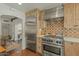 Modern kitchen with stainless steel appliances and light wood cabinets, flowing into the dining area at 1307 W Palm Ln, Phoenix, AZ 85007