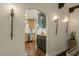 Charming kitchen view featuring terracotta tile flooring, arched doorway, and stylish lighting, and unique cabinet colors at 1307 W Palm Ln, Phoenix, AZ 85007