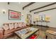 Cozy living room with dark hardwood floors, exposed beams, stylish furnishings, and an open layout at 1307 W Palm Ln, Phoenix, AZ 85007