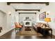 Bright living room featuring dark wood floors, exposed beams, a fireplace, and ample natural light at 1307 W Palm Ln, Phoenix, AZ 85007