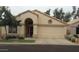 Charming single-story home features a well-manicured front yard and a two-car garage at 14465 W Winding Trl, Surprise, AZ 85374