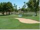 Scenic golf course with sand traps, serene pond, and well-manicured greenery at 14465 W Winding Trl, Surprise, AZ 85374