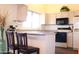 Bright eat-in kitchen with light-colored cabinets and breakfast bar at 14465 W Winding Trl, Surprise, AZ 85374