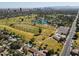 Expansive aerial view of a golf course with beautiful landscaping and a stunning city skyline backdrop at 1610 W Wilshire Dr, Phoenix, AZ 85007