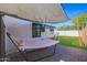 Inviting backyard featuring a shady hammock under a sun shade, perfect for relaxation on the brick patio at 1610 W Wilshire Dr, Phoenix, AZ 85007