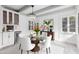 Well lit dining room with white walls, glass dining table, and white chairs at 1610 W Wilshire Dr, Phoenix, AZ 85007