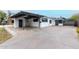 Charming home featuring a covered carport, stylish dark trim, and a well-maintained concrete driveway at 1610 W Wilshire Dr, Phoenix, AZ 85007