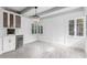 Inviting living room featuring white brick walls, ample lighting, and a built in bar area at 1610 W Wilshire Dr, Phoenix, AZ 85007