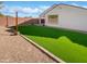 View of the backyard featuring green grass and rock landscaping at 16416 W Cottontail Ln, Surprise, AZ 85387