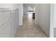 A home's entryway features stylish wall paneling and tile flooring, inviting guests into the spacious interior at 16416 W Cottontail Ln, Surprise, AZ 85387