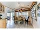 Inviting dining room with tile floors, a chandelier, and a large window with sun blocking blinds at 17200 W Bell Rd # 26, Surprise, AZ 85374