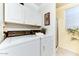 Practical laundry room with modern appliances and built-in storage cabinets at 17200 W Bell Rd # 26, Surprise, AZ 85374