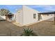 View of the home's backyard with desert landscaping, privacy walls, and pergola covered patio at 1725 N Date -- # 23, Mesa, AZ 85201