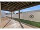 Backyard featuring a covered patio, decorative block wall, and low maintenance landscaping at 1725 N Date -- # 23, Mesa, AZ 85201