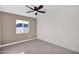 Bedroom features neutral carpet, modern ceiling fan, and a window providing natural light at 1725 N Date -- # 23, Mesa, AZ 85201