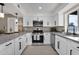 Well-lit kitchen with white cabinetry, stainless steel appliances, and stone countertops at 1725 N Date -- # 23, Mesa, AZ 85201