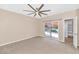 Carpeted bedroom featuring a ceiling fan, a sliding glass door to the backyard, and a closet at 17309 E Rosita Dr, Fountain Hills, AZ 85268