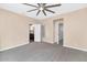 Carpeted bedroom with multiple doorways, a ceiling fan, and neutral-colored walls at 17309 E Rosita Dr, Fountain Hills, AZ 85268