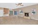 Cozy living room with a stone fireplace and a sliding glass door leading to the outside at 17309 E Rosita Dr, Fountain Hills, AZ 85268