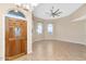 Open living space with a decorative front door, arched windows, neutral walls, chandelier, and tiled flooring at 17309 E Rosita Dr, Fountain Hills, AZ 85268