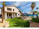 Spacious backyard with well manicured artificial grass, an inviting pool and a cozy hammock for outdoor relaxation at 1865 E Pinto Dr, Gilbert, AZ 85296