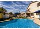 Inviting backyard pool area complete with a basketball hoop, landscaping, and a covered patio at 1865 E Pinto Dr, Gilbert, AZ 85296