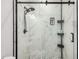 Close up of bathroom tile shower with glass door and matte black hardware and fixtures at 1865 E Pinto Dr, Gilbert, AZ 85296