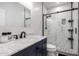 Modern bathroom featuring marble countertops, tiled shower with glass door, and matte black fixtures at 1865 E Pinto Dr, Gilbert, AZ 85296