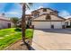 Inviting two-story home with a three-car garage and lush green lawn at 1865 E Pinto Dr, Gilbert, AZ 85296