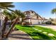 Charming home with a well-manicured lawn, stepping stones, and palm trees at 1865 E Pinto Dr, Gilbert, AZ 85296