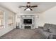 Comfortable living room with a modern entertainment center and ceiling fan at 1865 E Pinto Dr, Gilbert, AZ 85296