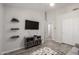 Living room features gray wood floors, ceiling fan and built-in shelving at 1865 E Pinto Dr, Gilbert, AZ 85296