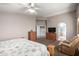 Large primary bedroom with ensuite bathroom, ceiling fan and wood furniture at 1865 E Pinto Dr, Gilbert, AZ 85296